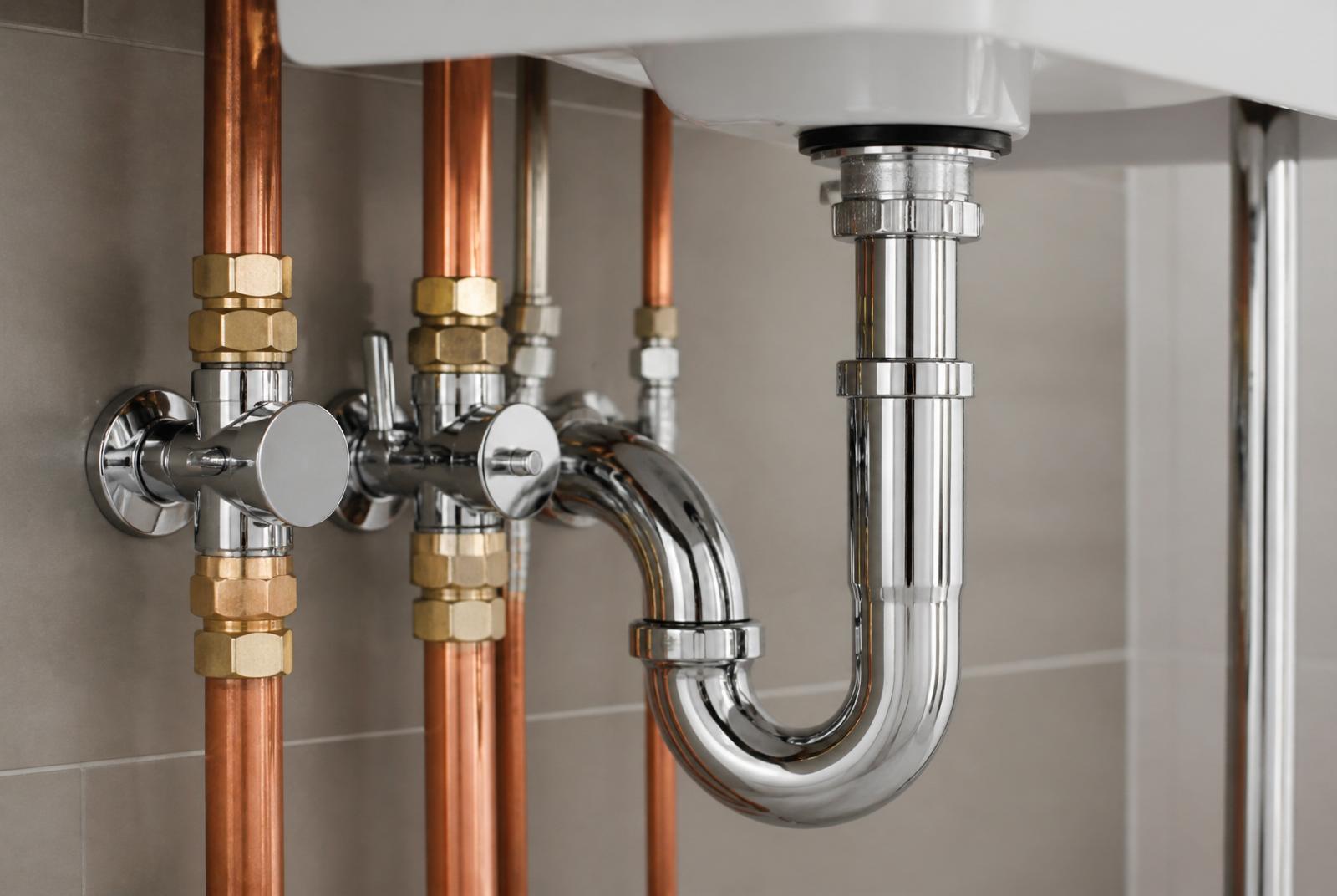 Copper pipework, isolation valves and chrome trap on a professional plumbing installation by Novopro, Bournemouth